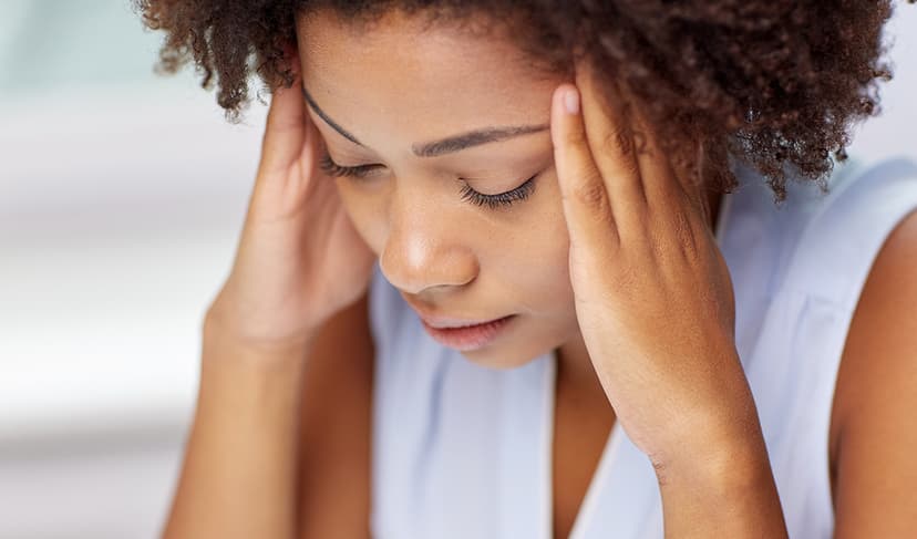 Woman holding her head due to stress