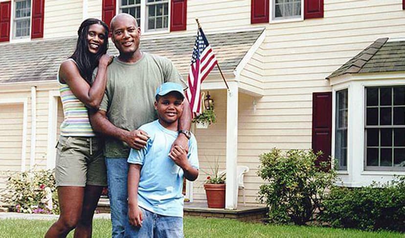 Family standing in front of a house