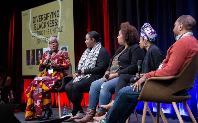 People seated onstage engaged in a panel discussion