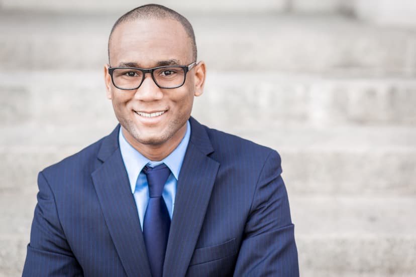 Rhoden Monrose smiling dressed in blue suit