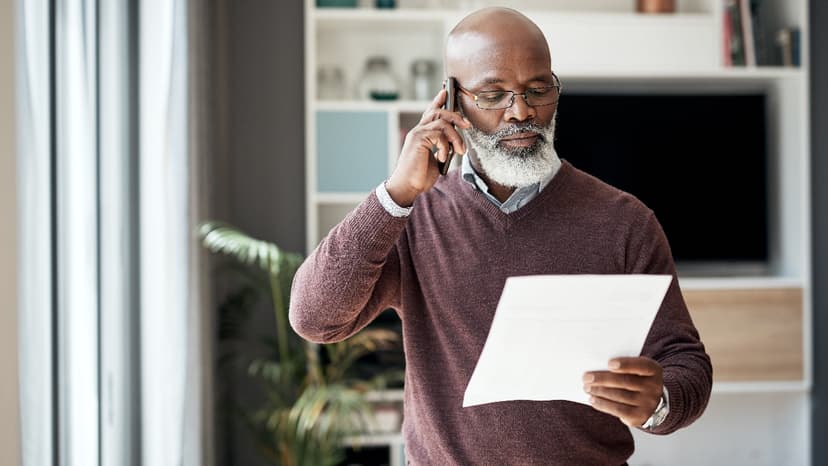 Man standing, talking on the phone