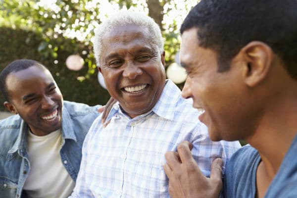 3 Black men smiling outdoors