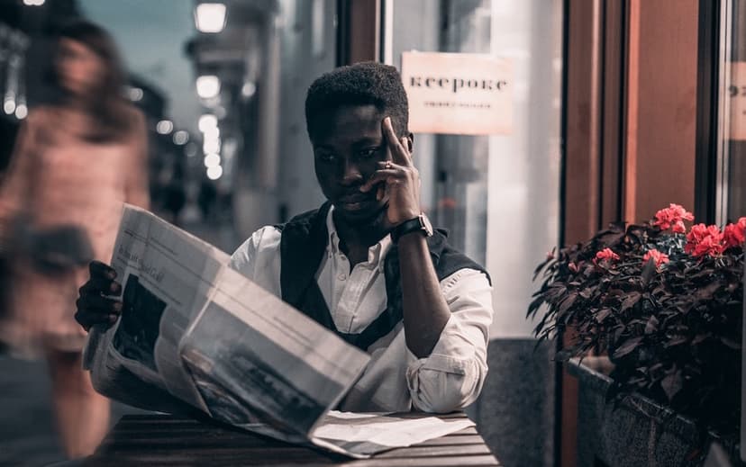 Black man reading newspaper