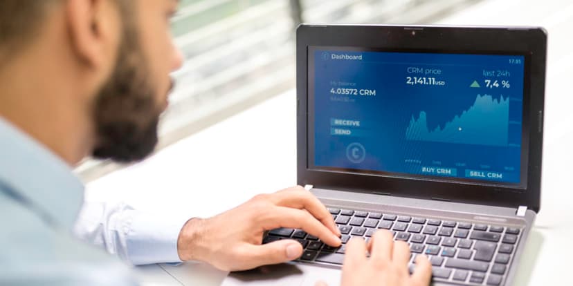 Man looking at market info on a computer screen