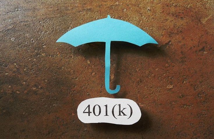 An aqua umbrella against a wood wall