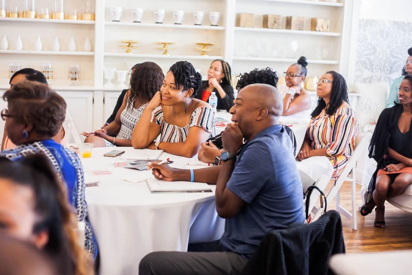 People sitting at tables at an event