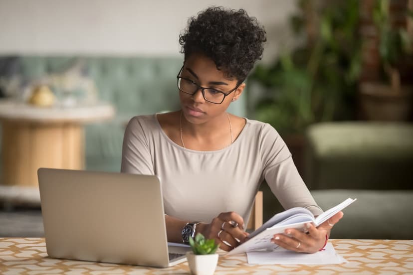 A woman reading from a laptop