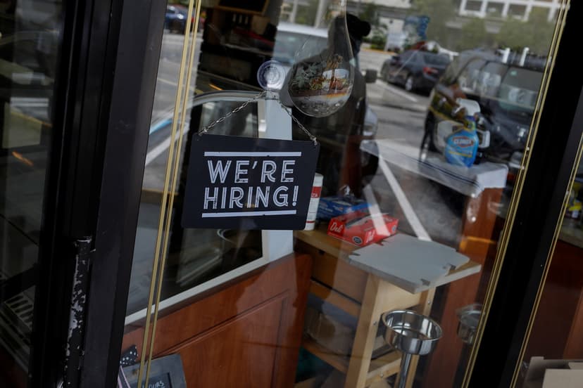 We're Hiring signage in a storefront