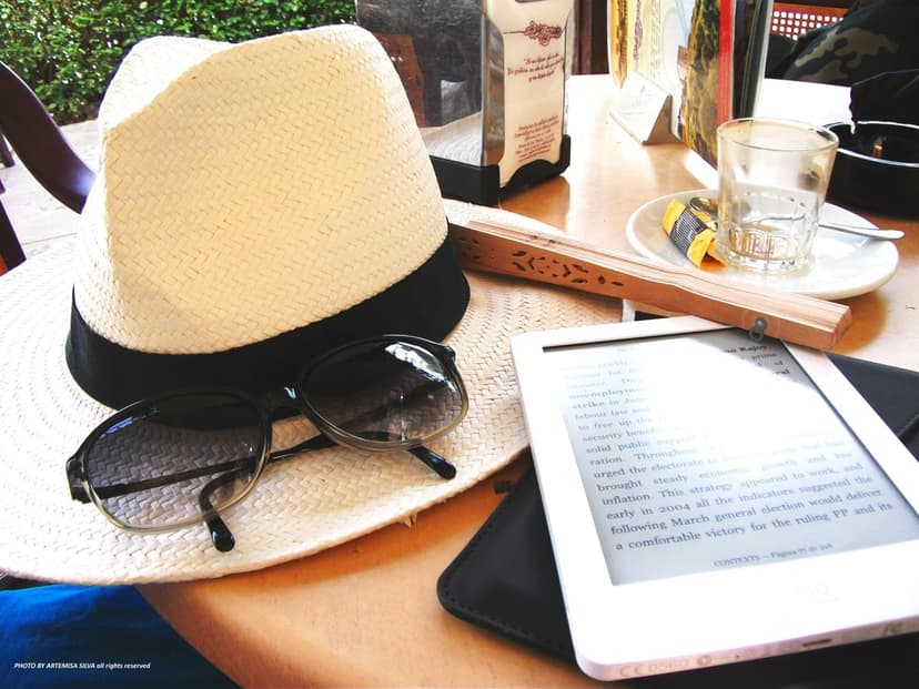 A hat, sunglasses and tablet