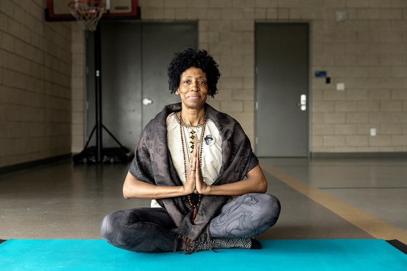 Woman sitting on the ground in a yoga position