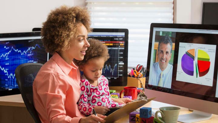 A woman and her baby at a computer