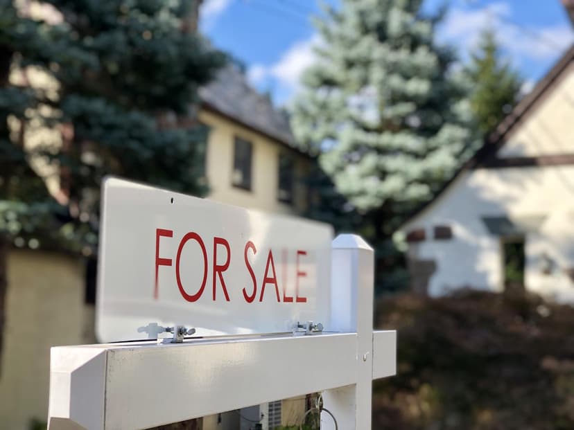 Home with a For Sale sign out front