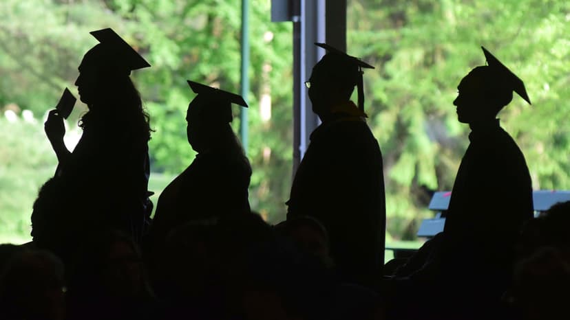 A procession of grads dressed in gowns