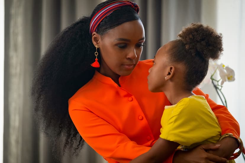 Woman in bright orange shirt holding a little girl