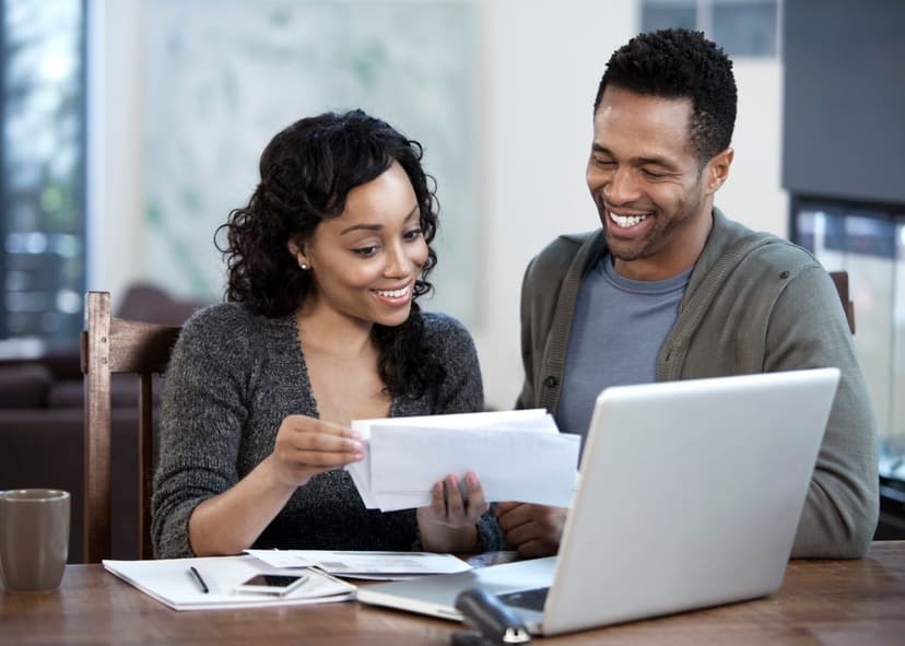 A couple discussing information on paperwork