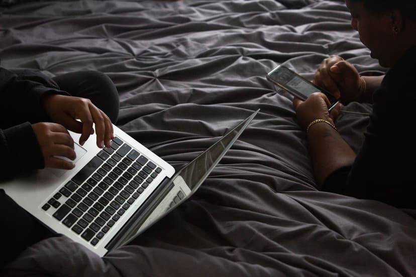 Two people using a laptop