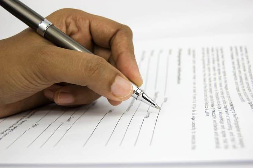 man signing a page