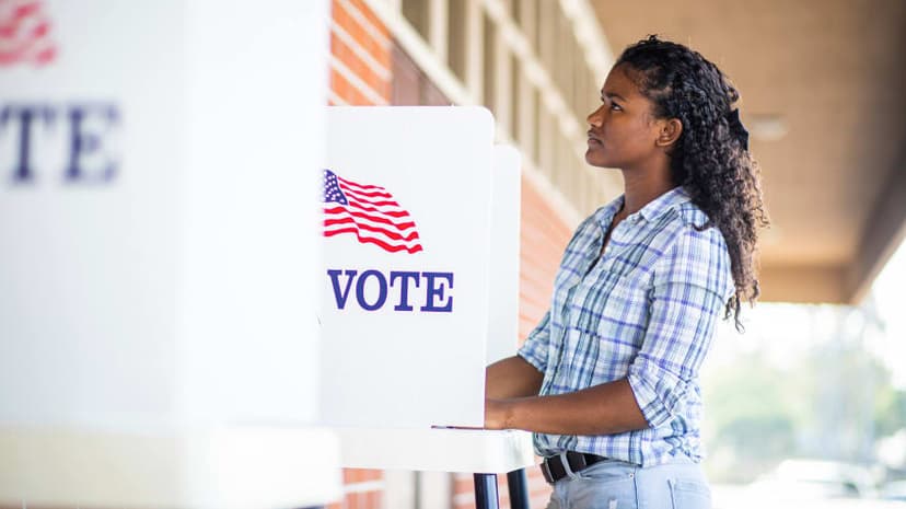 woman standing in a voting booth