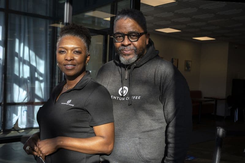 Black couple posing wearing Black t-shirts