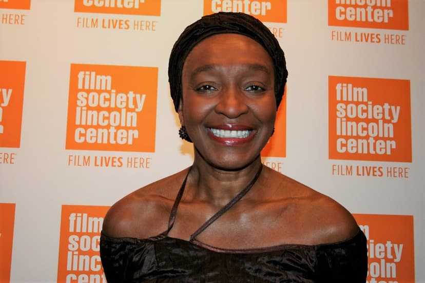 Woman smiling wearing black top and scarf