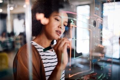 Woman writing on glass