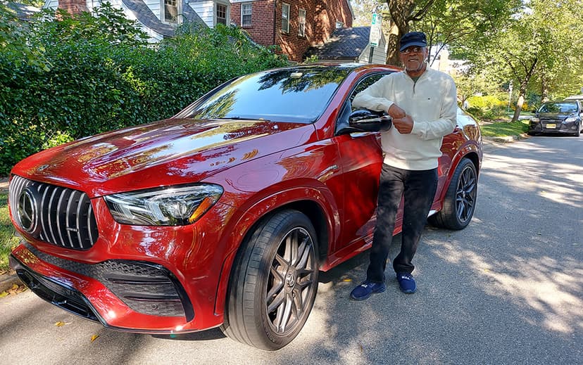 Man standing in front of a red SUV