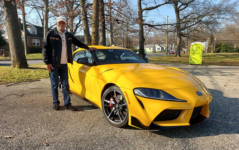 Man standing beside yellow sports car